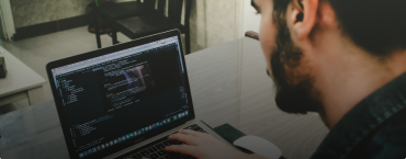 A man coding on a computer.