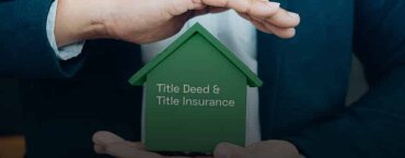 A man holding and protecting a small green house, with the words "Title Deed & Title Insurance" on the house.